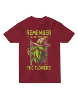 "White ‘Remember to Stop and Smell’ t-shirt with abstract daisy graphic, modeled in a sunflower field for nature-inspired humor"